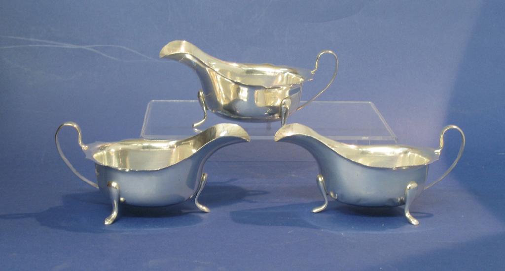 Appraisal: A PAIR OF SAUCEBOATS of shaped oval form with scroll