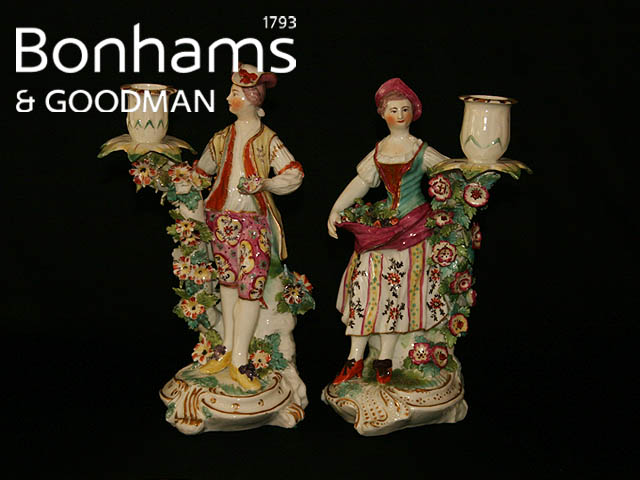 Appraisal: A pair of English porcelain figural candlesticks modelled as a