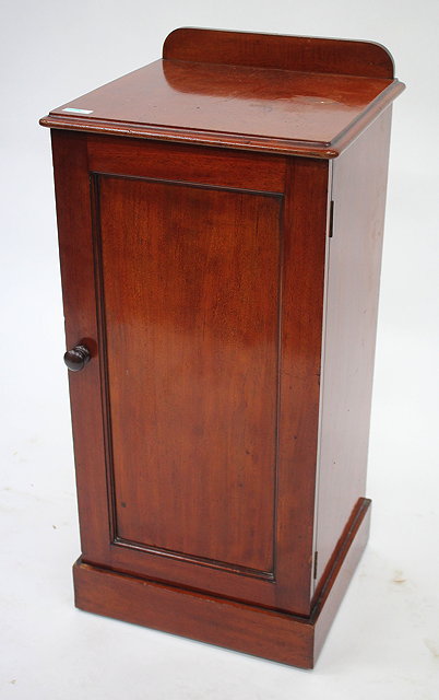 Appraisal: A VICTORIAN MAHOGANY POT CUPBOARD with panelled door and plinth