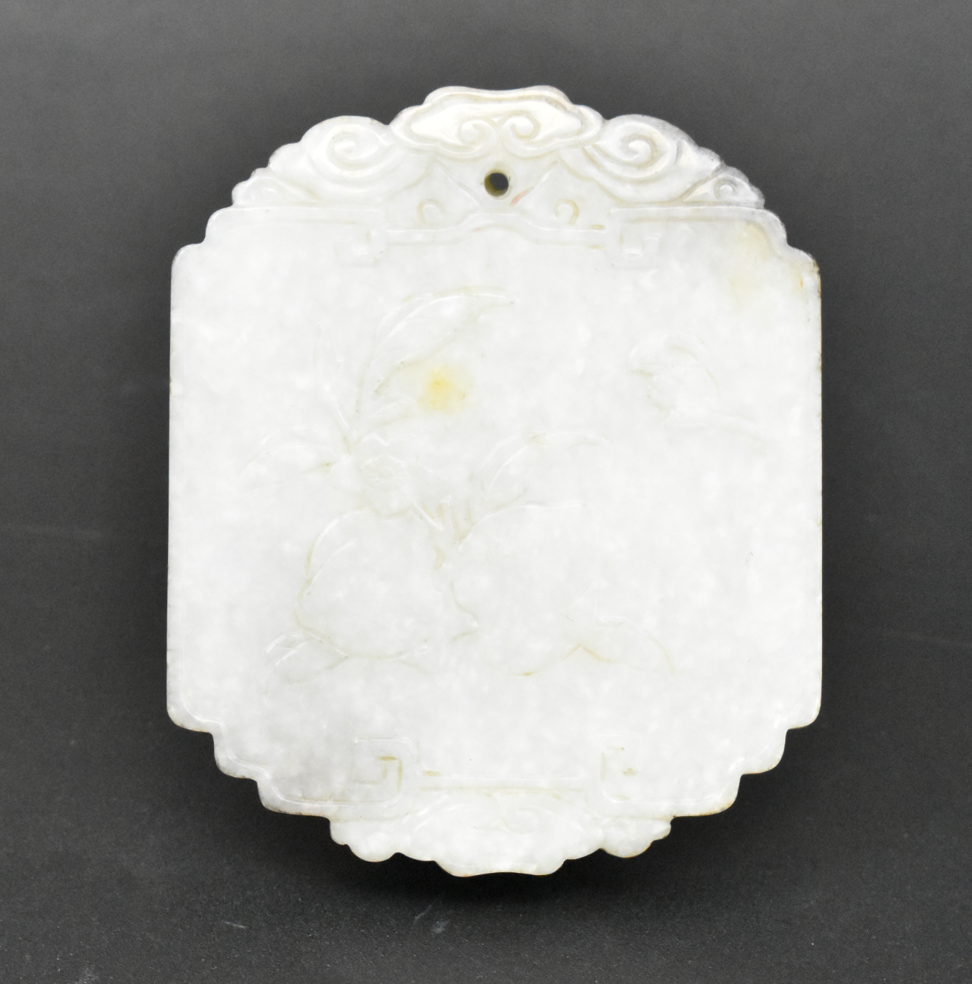 Appraisal: A Chinese jade carved plaque with peach design dating from