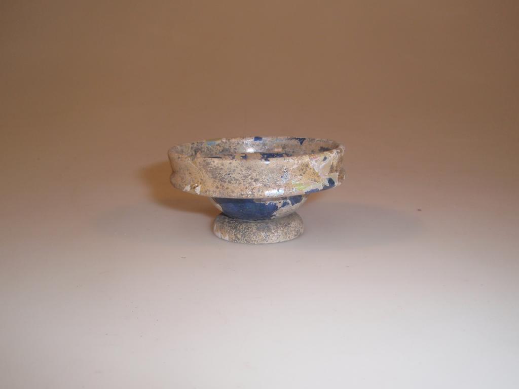 Appraisal: A small Roman dark blue glass bowl the folded collar