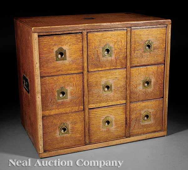 Appraisal: An English Oak and Brass-Mounted Nine Drawer Campaign Cabinet c