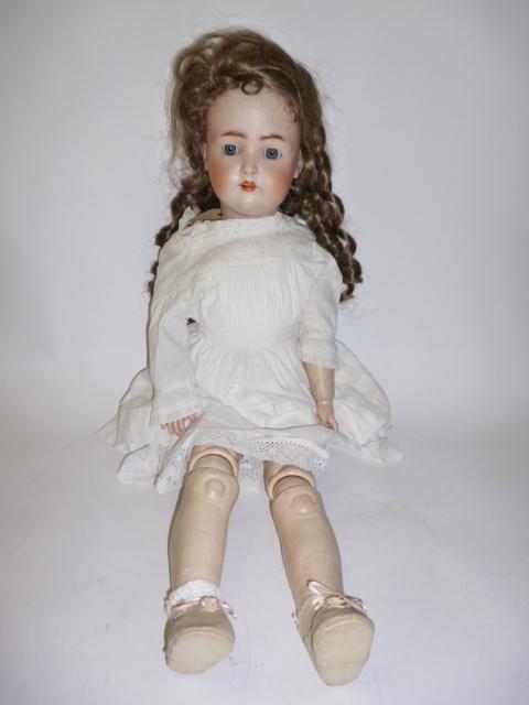 Appraisal: A German bisque head girl doll probably Kestner with blue