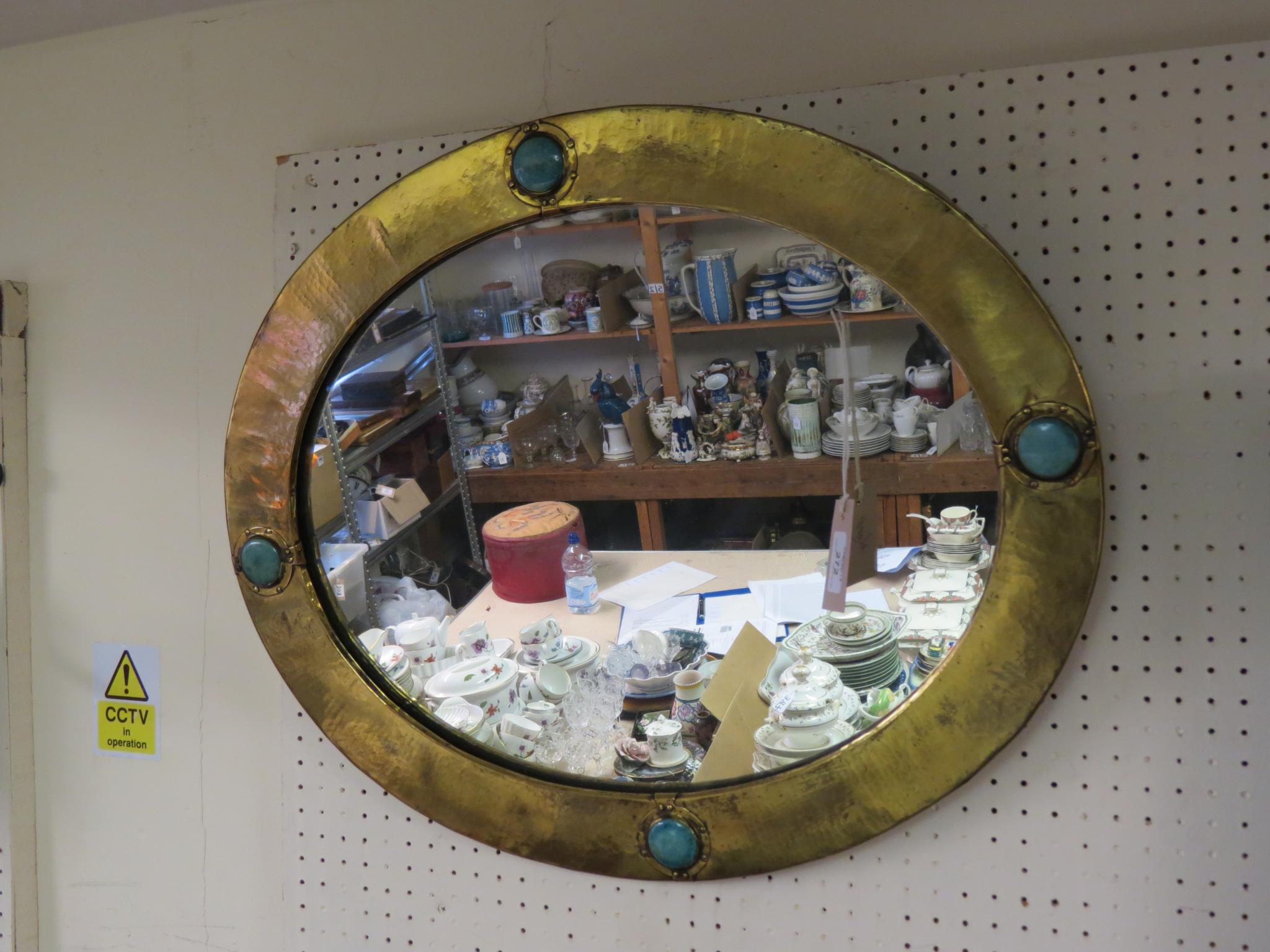 Appraisal: A Liberty Co hammered brass mirror oval-shape frame inset with