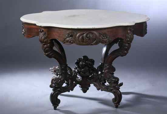 Appraisal: ROCOCO REVIVAL CARVED MAHOGANY CENTER TABLE Serpentine marble top having