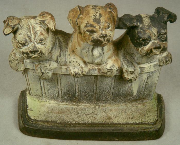 Appraisal: Cast iron doorstop three puppies in basket base stamped Copyright