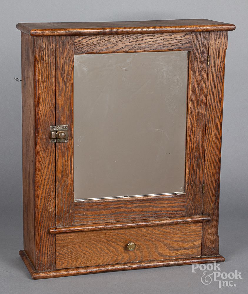 Appraisal: Mirrored oak hanging cabinet ca Mirrored oak hanging cabinet ca