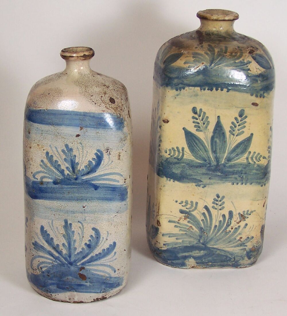 Appraisal: Two early th century blue painted maiolica bottles Probably Italian