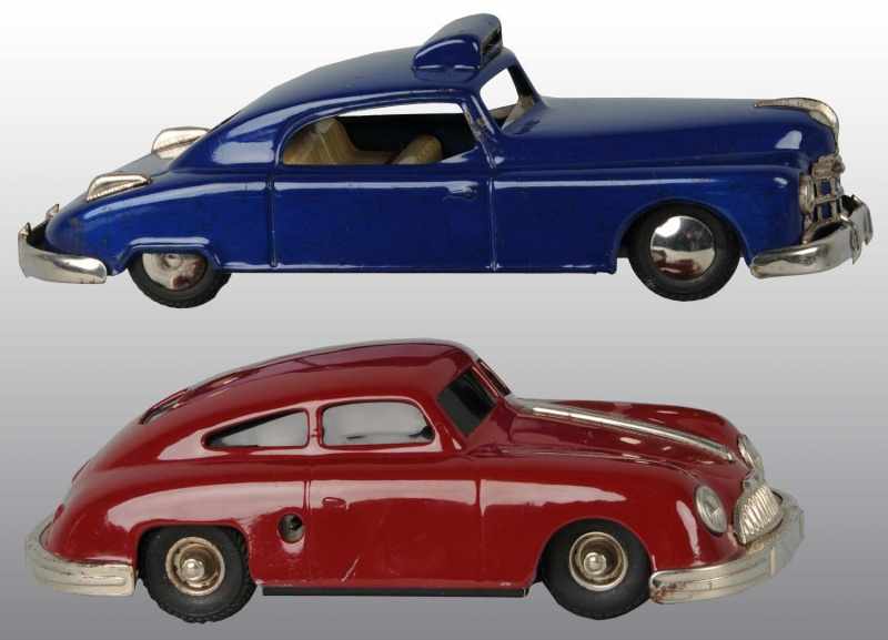 Appraisal: Lot of Tin Automobile Wind-Up Toys Description German Working Both