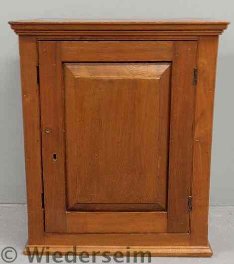 Appraisal: Pennsylvania walnut hanging cupboard c with a molded cornice chamfered