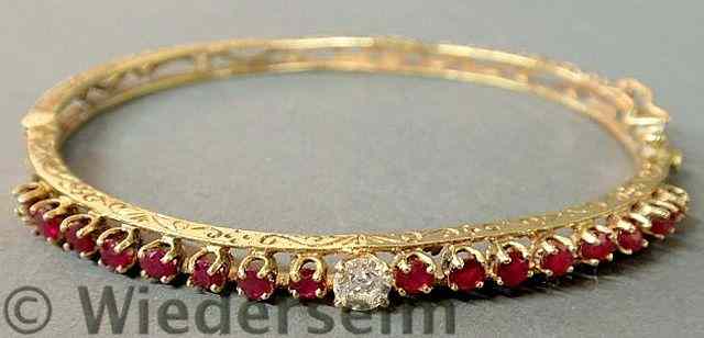 Appraisal: Ruby and diamond k yg filigree bangle bracelet with rubies