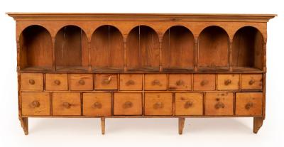 Appraisal: A pine spice rack with a seven-arch top recesses over