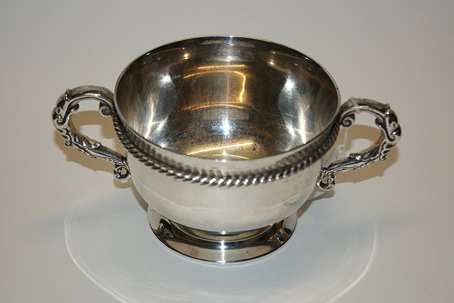 Appraisal: A SILVER PORRINGER with rope-twist band London grams