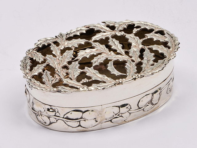 Appraisal: Silver boxof oval form with embossed borders and pierced holly