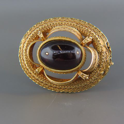 Appraisal: Garnet Brooch oval cabachon inantique k yellow gold setting overall