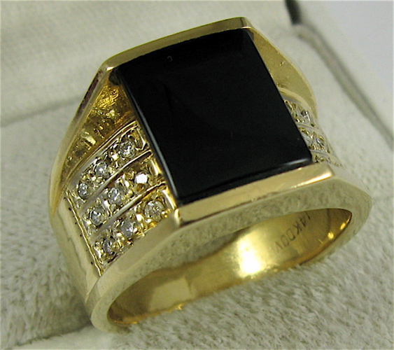 Appraisal: MAN'S BLACK AND DIAMOND ONYX RING K YG centering an