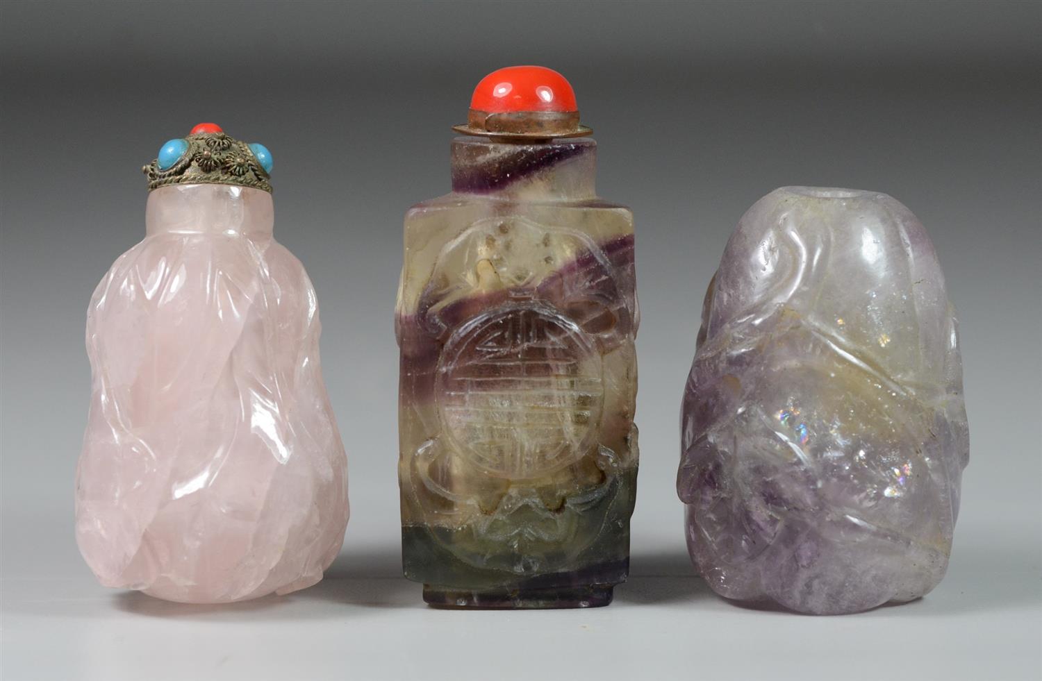 Appraisal: Carved amethyst crystal Chinese snuff bottles lacking stopper tallest