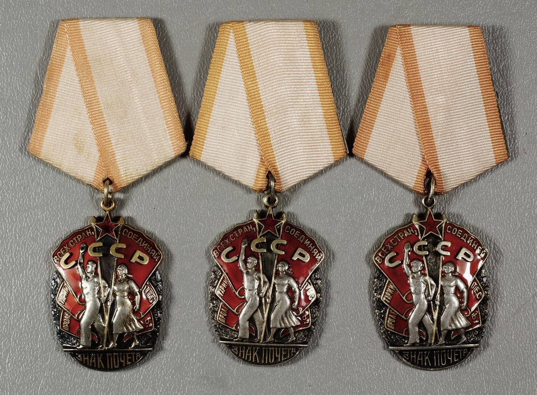 Appraisal: Soviet red enameled medals depicting a couple walking carrying banners