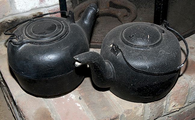 Appraisal: Cast Iron Tea Kettles A pair of good cast iron