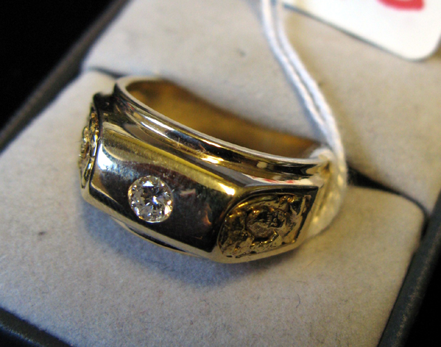 Appraisal: MAN'S DIAMOND AND FOURTEEN KARAT GOLD RING centering a round