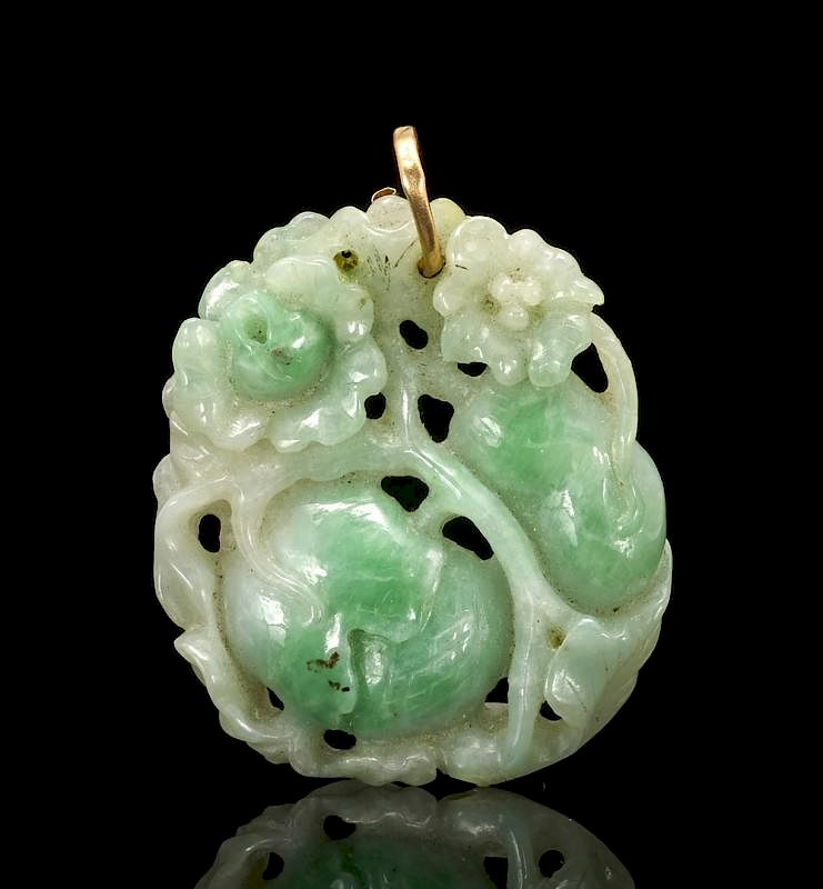 Appraisal: Green jade pendant through carved with flowers and fruit Green