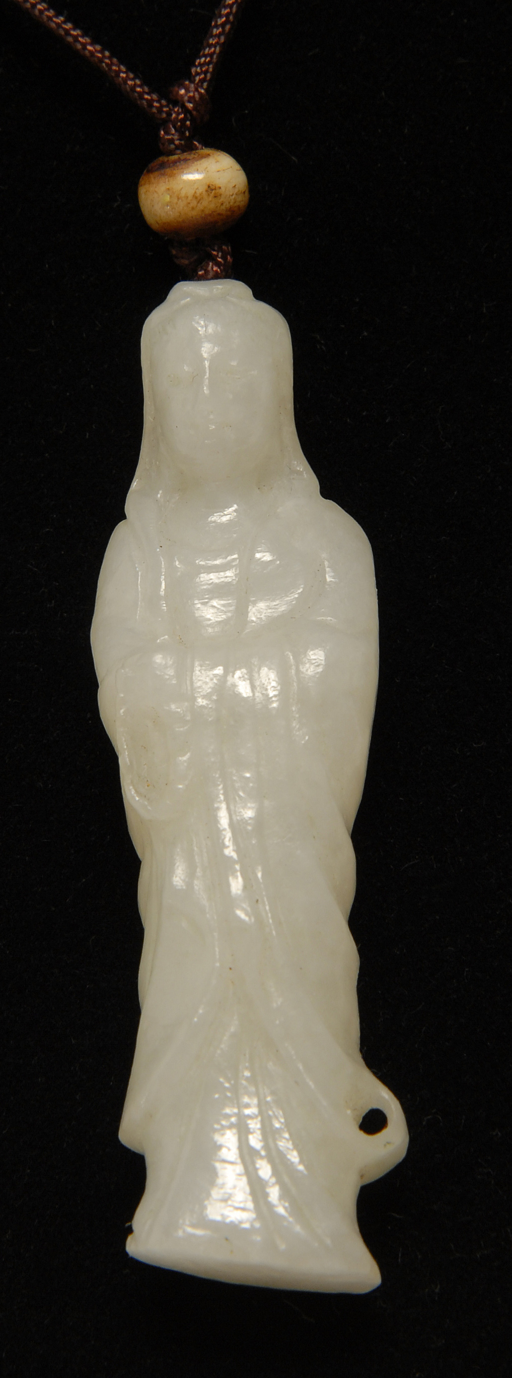 Appraisal: WHITE JADE PENDANT In the form of Guanyin standing while