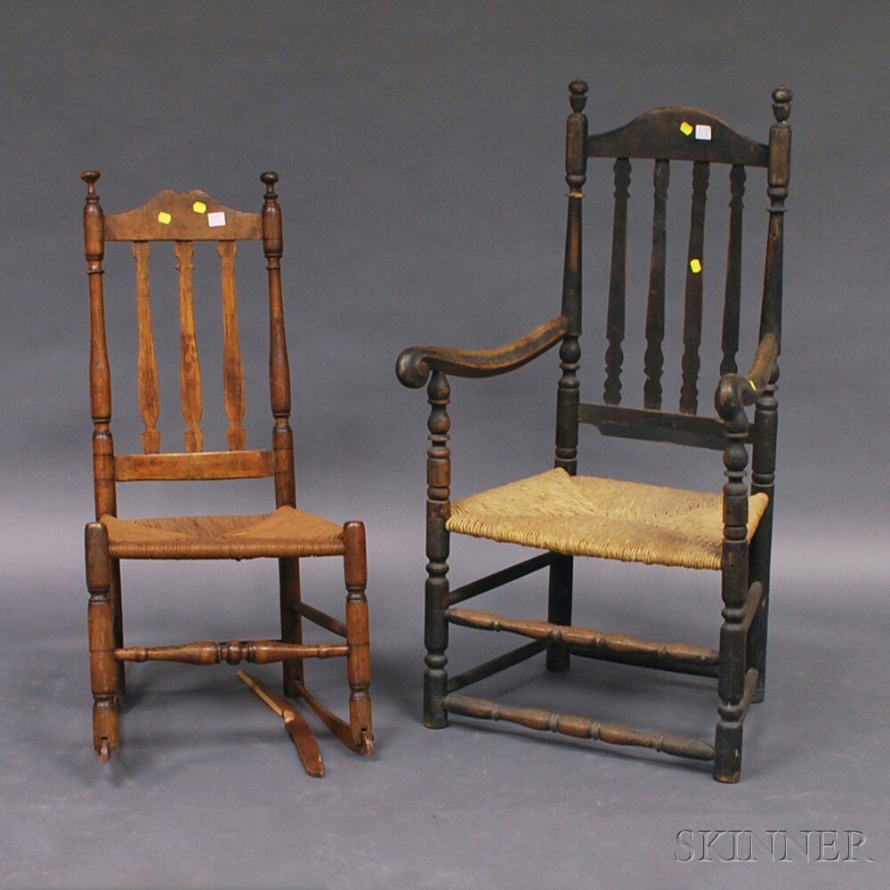 Appraisal: Two Bannister Back Chairs a black-painted armchair with acorn finials