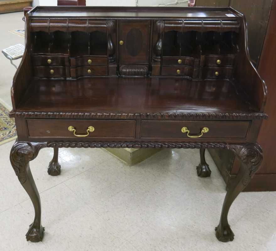 Appraisal: CHIPPENDALE STYLE MAHOGANY WRITING DESK featuring an open bank of