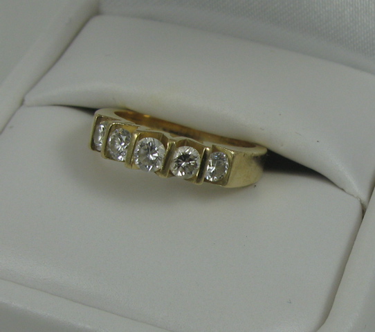 Appraisal: DIAMOND AND FOURTEEN KARAT GOLD RING set with five round