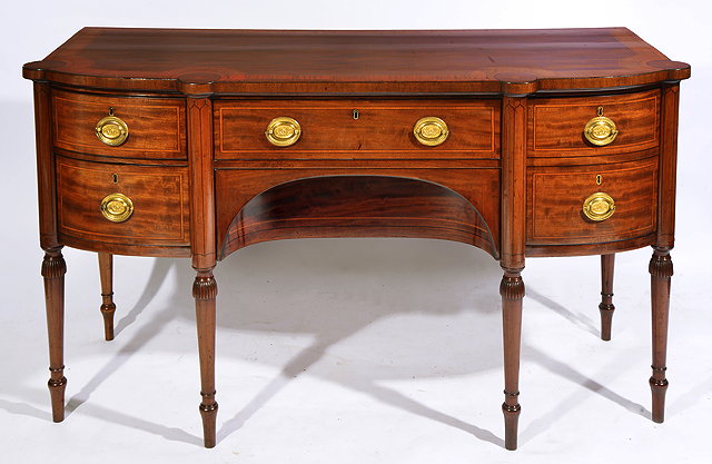 Appraisal: A WILLIAM IV BOW FRONTED MAHOGANY SIDEBOARD with cross banded