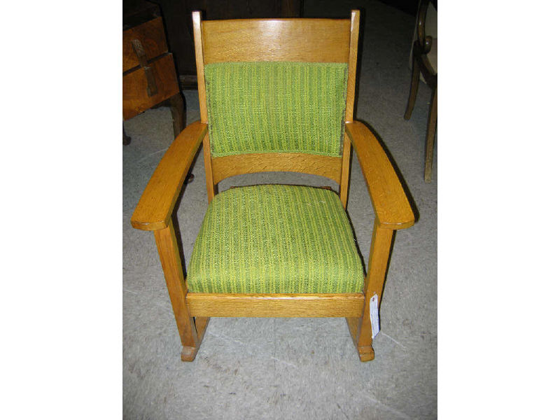 Appraisal: AMERICAN GOLDEN OAK ROCKER with paddle arms and green upholstery