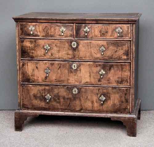 Appraisal: An th Century figured walnut chest of drawers with oak