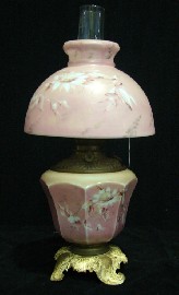 Appraisal: A pink glass oil lamp hand painted with floral sprays