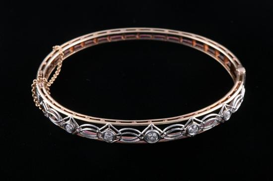 Appraisal: K YELLOW AND WHITE GOLD AND DIAMOND HINGED OVAL BANGLE