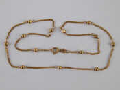 Appraisal: A carat gold necklace with gold beads approx cm long