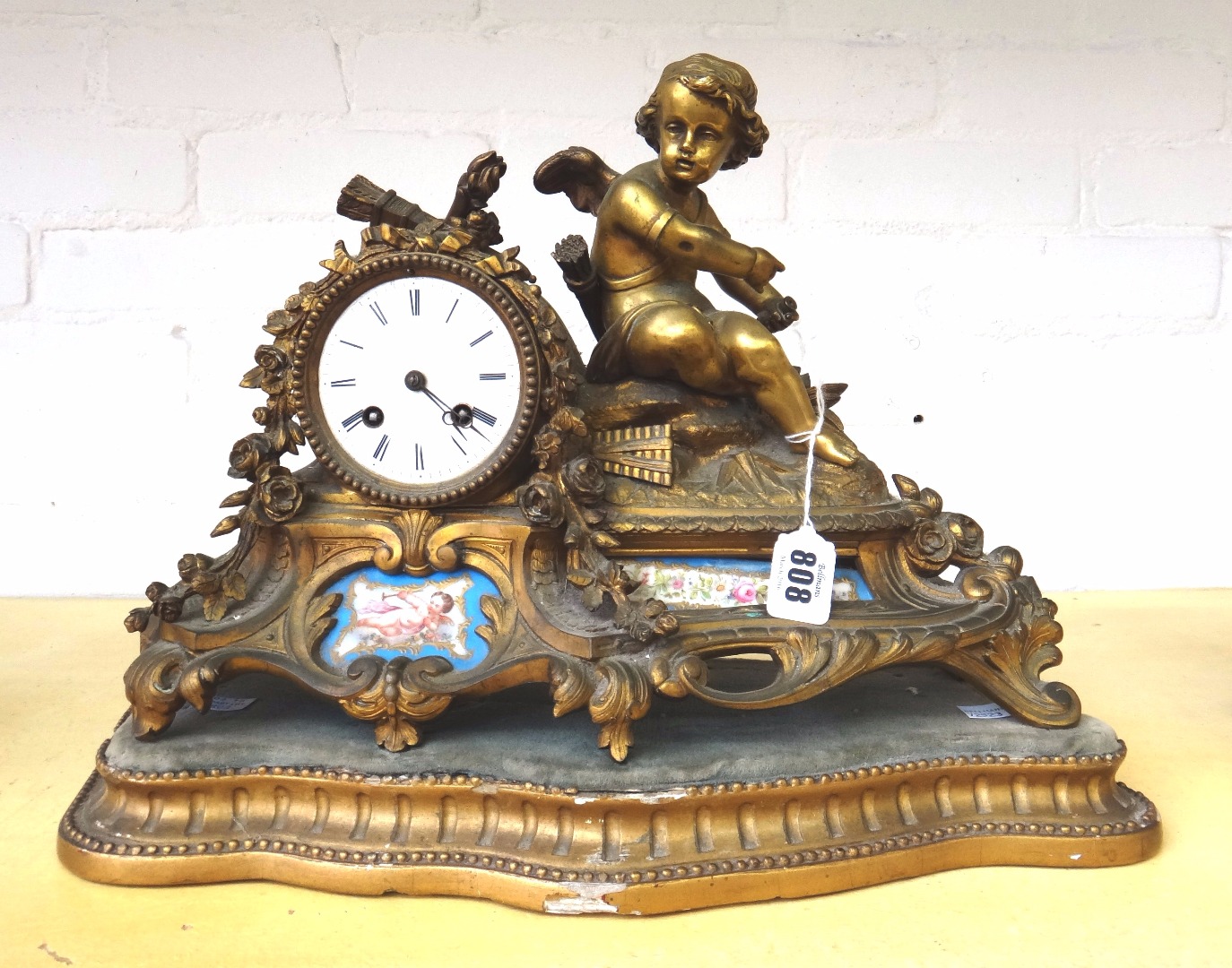 Appraisal: A French gilt spelter and porcelain inset figural mantel clock