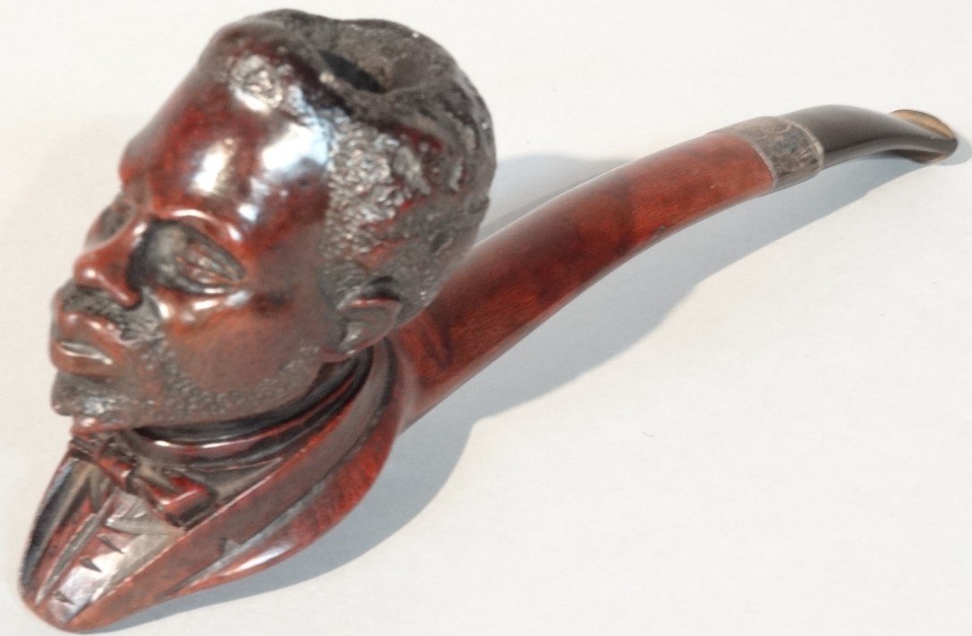 Appraisal: A late thC early thC heavily carved hardwood figural pipe