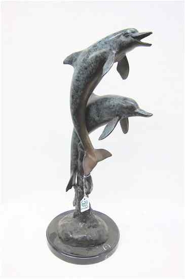 Appraisal: POLYCHROME BRONZE WILDLIFE SCULPTURE depicting two playful dolphins leaping out