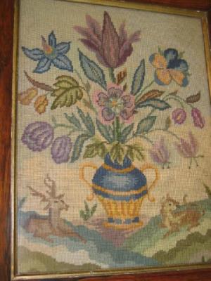 Appraisal: A VICTORIAN WOOLWORK PICTURE depicting a vase of flowers flanked