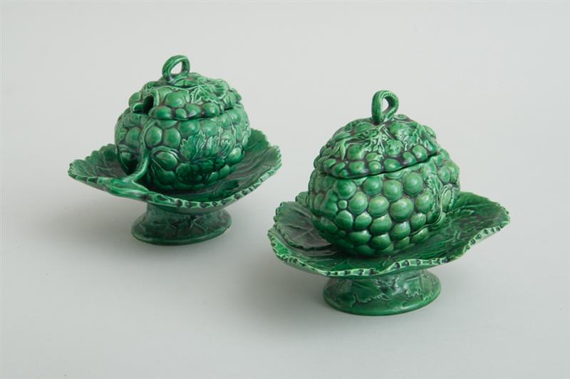 Appraisal: PAIR OF ENGLISH GREEN-GLAZED POTTERY GRAPE CLUSTER TUREENS ON ATTACHED