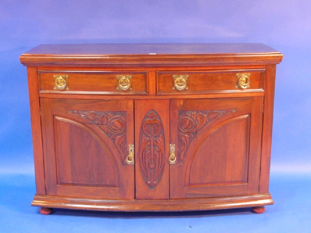 Appraisal: An Art Nouveau walnut sideboard the bow front having brass