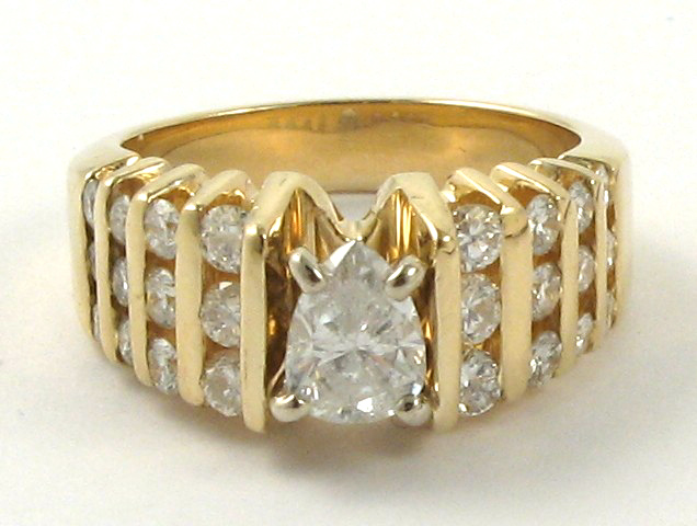 Appraisal: DIAMOND AND FOURTEEN KARAT GOLD RING centering a pear-cut diamond