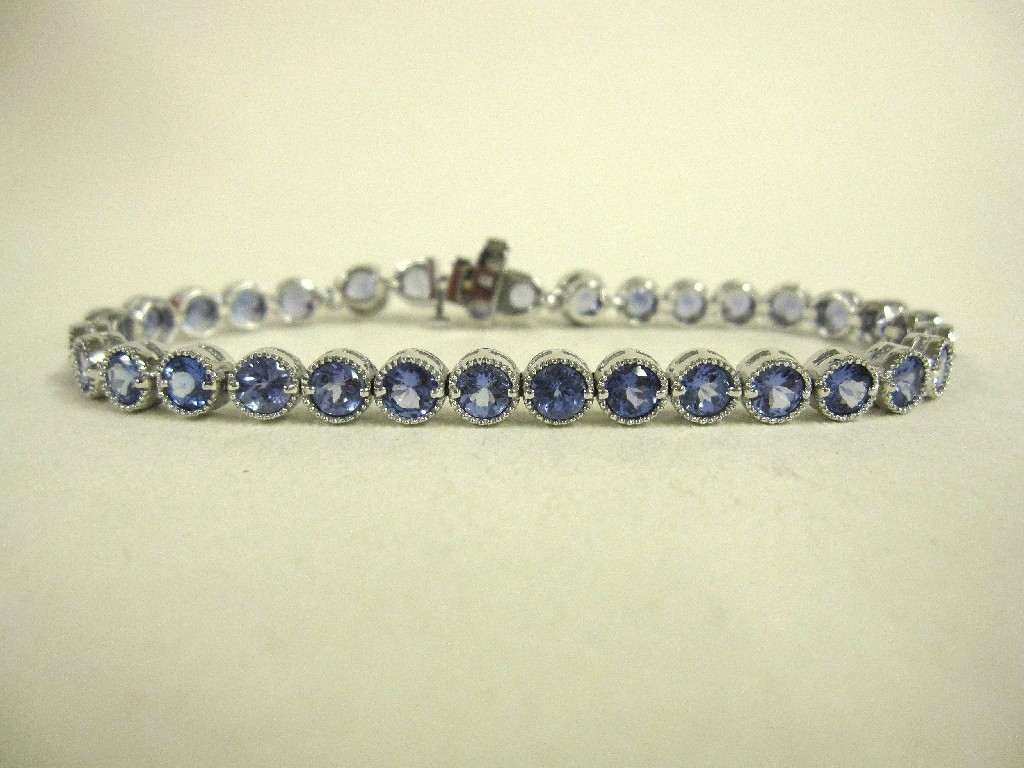 Appraisal: Eighteen carat white gold tanzanite and diamond set line bracelet