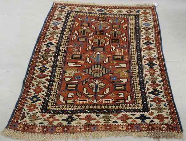 Appraisal: Colorful Caucasian throw carpet with geometric patterns and red field