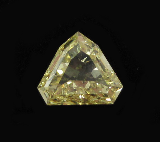 Appraisal: UNSET FANCY YELLOW SHIELD-CUT DIAMOND weighing approximately cts and measuring