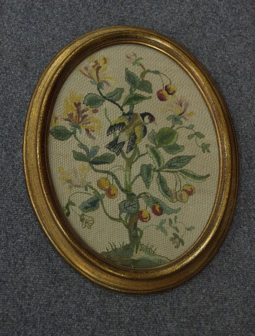 Appraisal: An oval needlework panel depicting a bird in a cherry