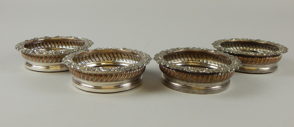 Appraisal: A set of four silver plated wine coasters each with