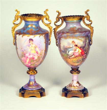 Appraisal: Pair of opalescent Sevres style gilt metal mounted porcelain urns