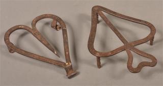 Appraisal: Two Various th Century Wrought Iron Trivets Both are heart