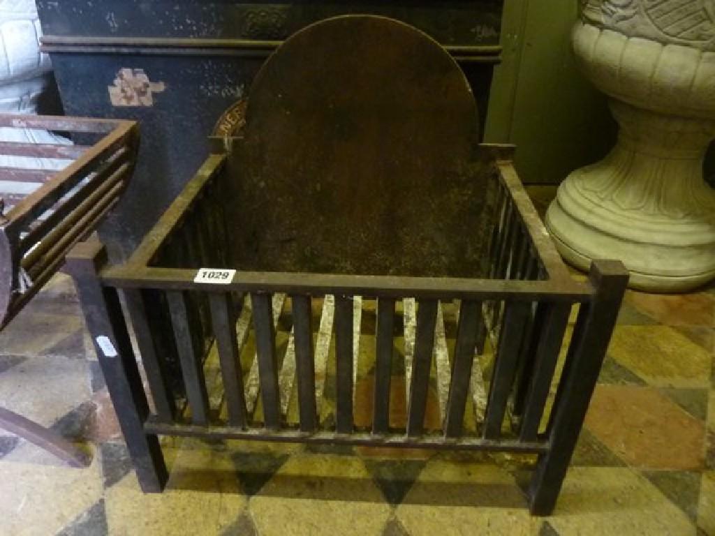 Appraisal: A simple cast iron fire basket with arched back plate